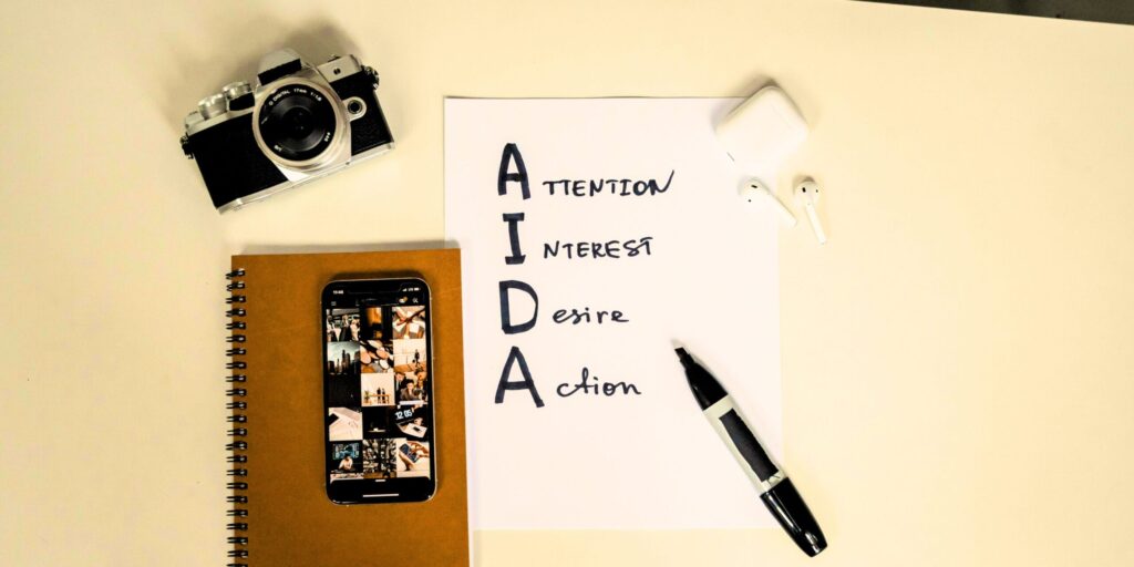 AIDA model hierarchy handwritten on paper by marketing professional